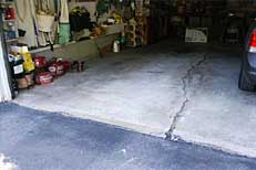 Garage or basement floor slab showing settling cracks