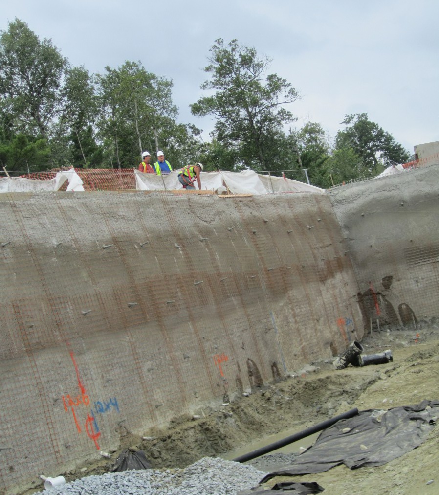 Excavation support using helical soil screws with shot crete